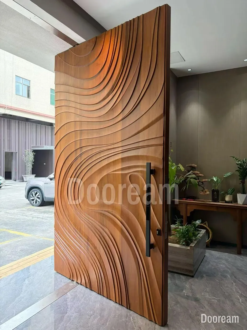 Flowing contour lines carved across a warm wood-tone face, with a long black pull that carries the smart lock.