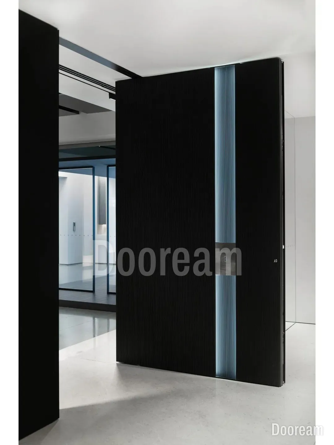 Black fluted aluminium with a full-height strip of soft blue light and a brushed steel lock plate. Sintered stone and a fluted walnut band on the inside.