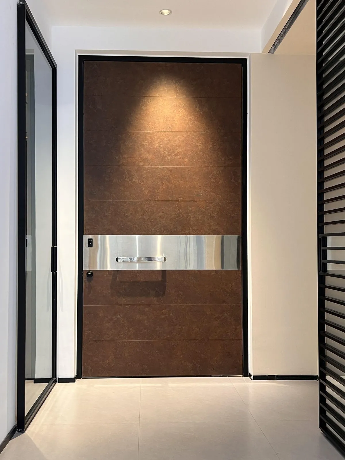Wood-grain printed panels in a warm brown tone, split by a brushed metal band that carries the handle.