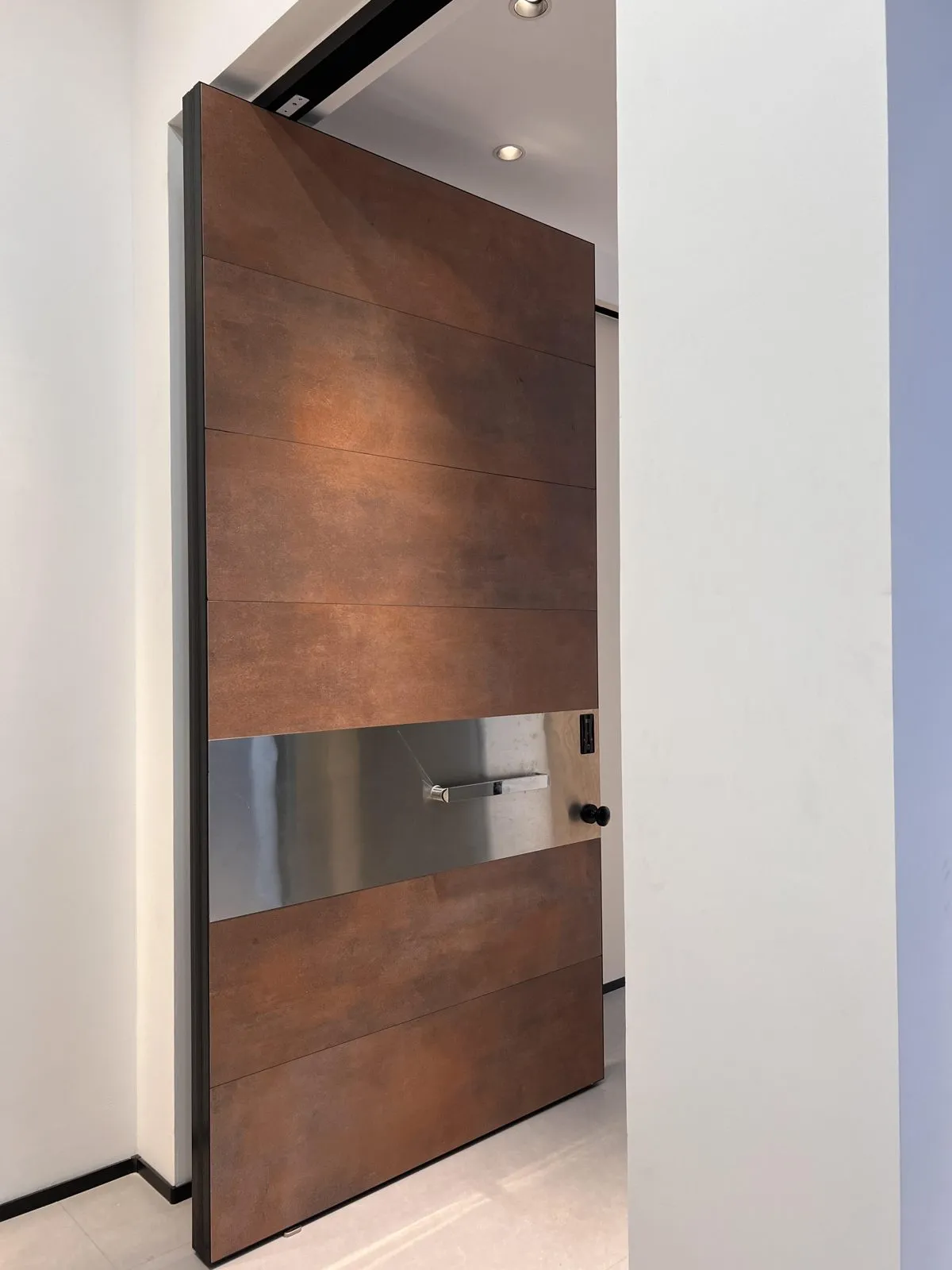 Wood-grain printed panels in a warm brown tone, split by a brushed metal band that carries the handle.