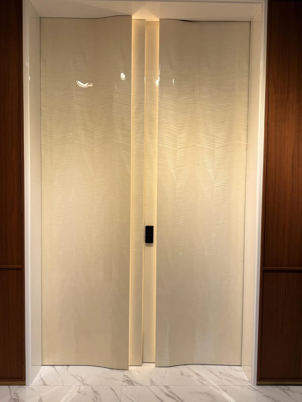 Ivory leaves with a soft vertical wave texture and a recessed light strip.