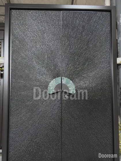 Dark textured double door with a jade fan handle, photographed on our floor