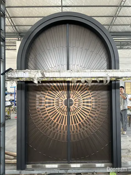 Arched door with a bronze sunburst, photographed on our floor
