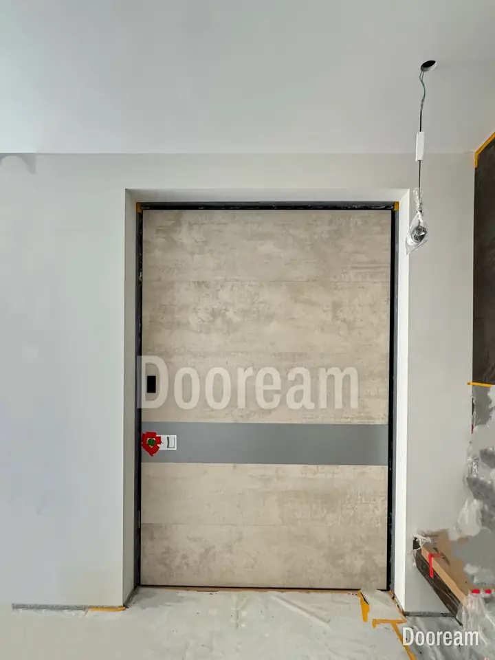 Light-grey stone-effect door with a dark band, installed