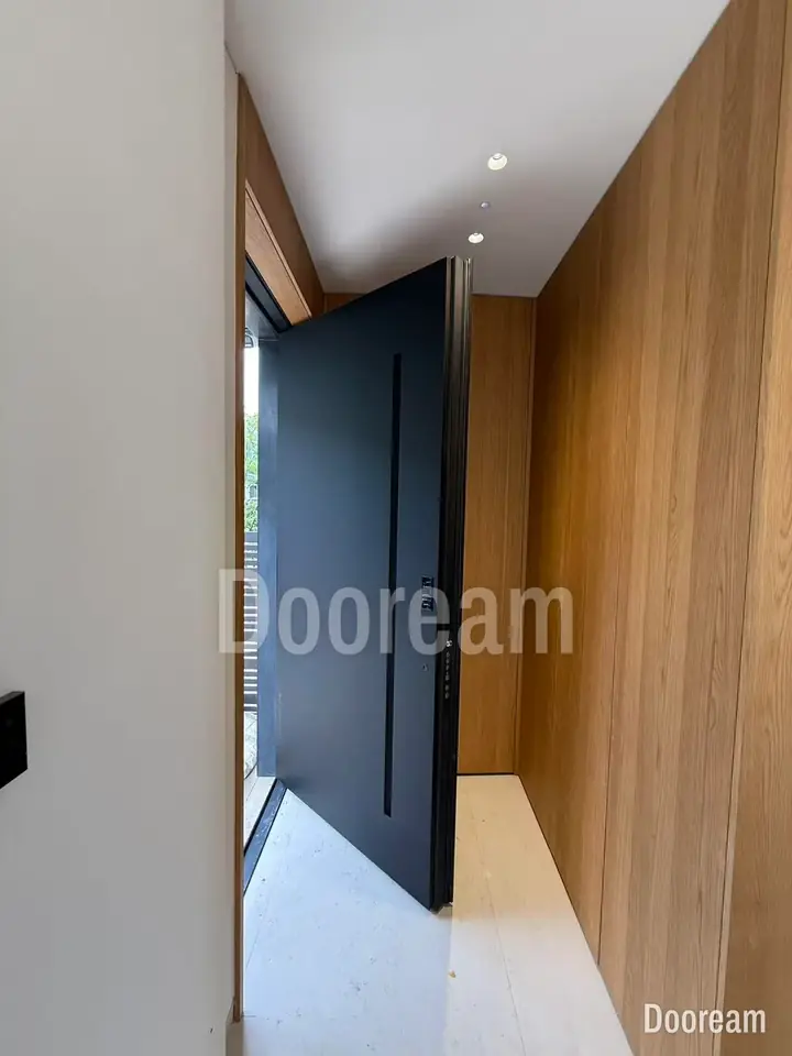 Black single door set into a timber-clad wall, installed