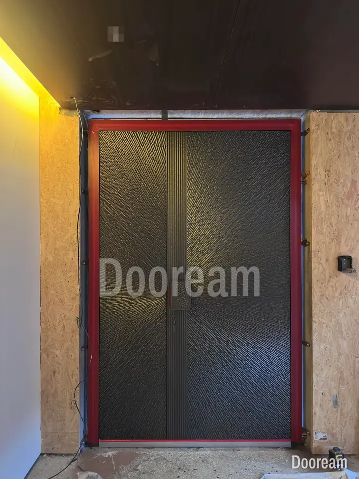 Dark textured unequal double door, during fitting, installed