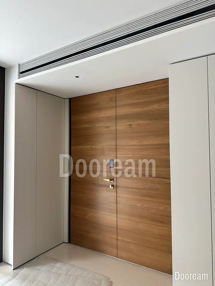 Light wood-tone double door against pale walls, installed