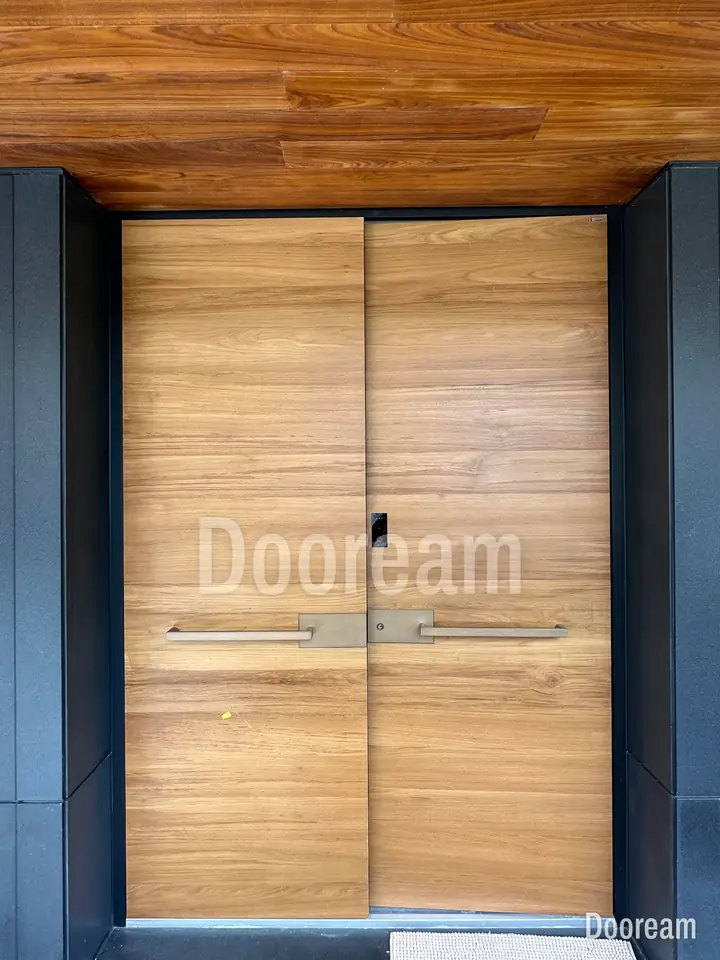 Wood-tone double door with horizontal metal strips, installed