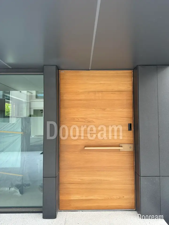 Wood-grain single door with a long horizontal handle and a glass sidelight, installed