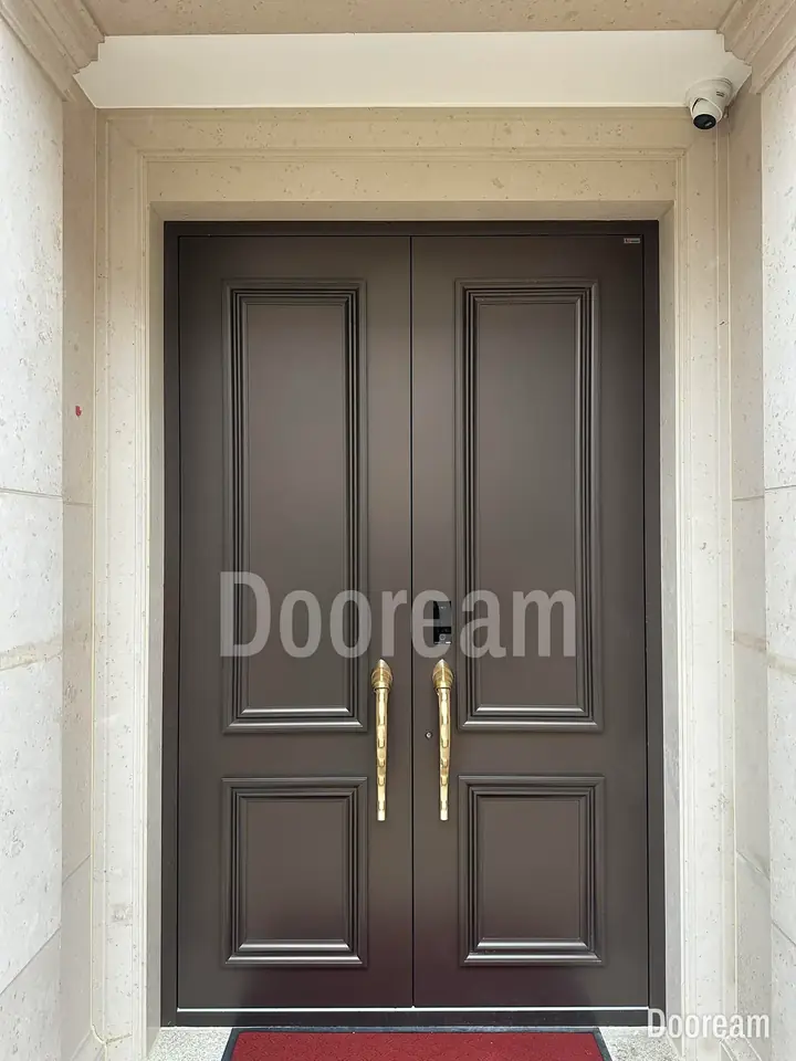 Dark classic double door with long curved gold handles, installed