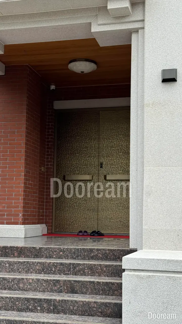 Gold textured double door at a red-brick, European-style villa, installed
