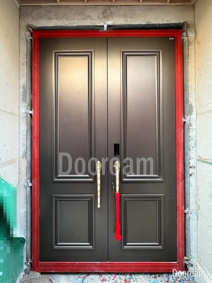Dark classic double door with curved gold handles, installed