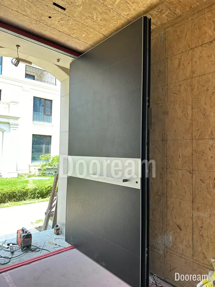 Dark-grey single door with a silver band, in a stone porch, installed