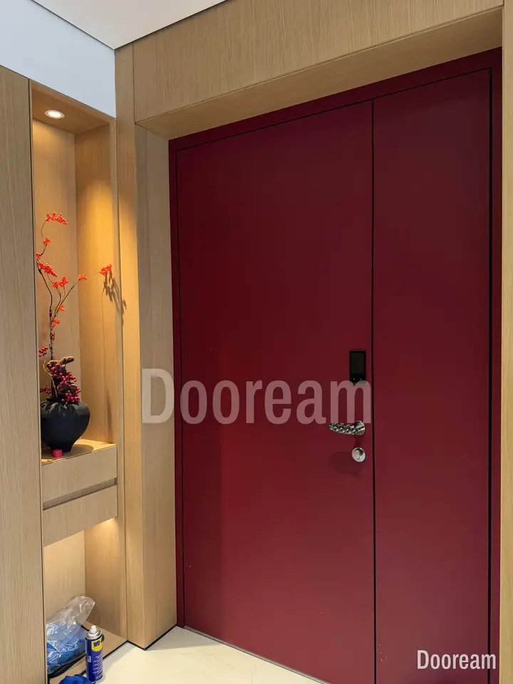 Wine-red unequal double door with a carved round handle, installed