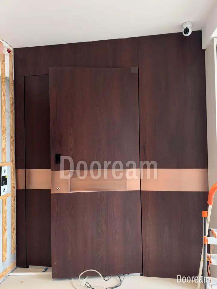 Dark wood-tone entrance door with a bronze band, installed
