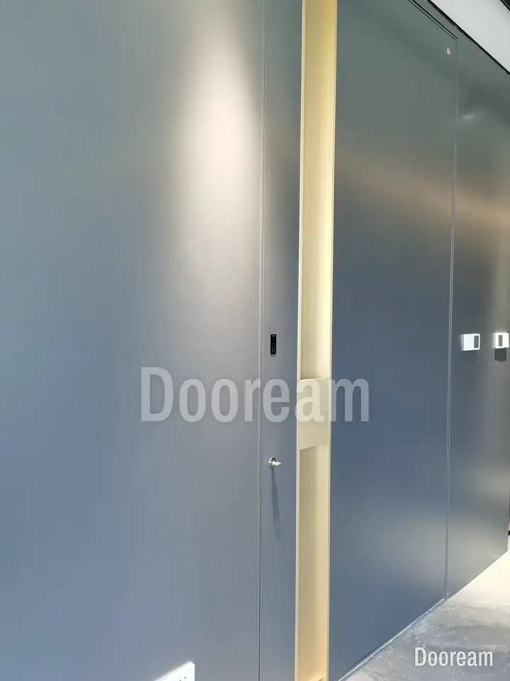 Grey door with a vertical gold strip, with lock-edge details, installed